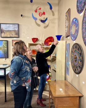 <p>These ladies discussing the incredible work of the Sol Sisters mosaics!</p>